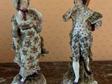 two figurines that are sitting on a table