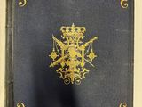 un livre bleu orné de dorures et d'une couronne
