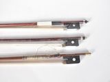 three different types of violin bows on a white surface