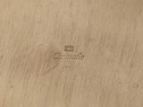 an image of a close up of a piece of wood with a logo on it