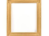 a gold frame on a white wall with a white background