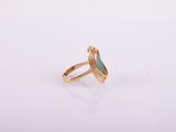 a gold ring with a green stone in the middle