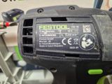 a close up of a black and green corded drill