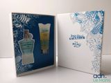 an open box containing a bottle of perfume and a tube of lotion