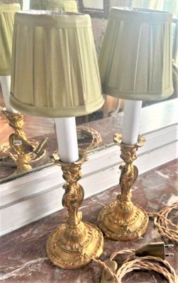 two lamps that are sitting on a table in front of a mirror