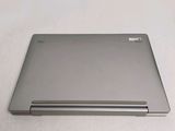 a laptop that is sitting on a white surface