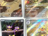 several pokemon cards are displayed on a table in a room
