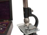 a microscope and a box with a ring inside of it