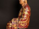 an image of a statue of a man sitting on a chair