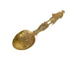 a gold spoon with a picture of a man and a woman on it