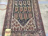 an oriental rug with fringes on the ground