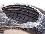 a close up of a motorcycle tire wrapped in plastic