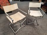 pair of chrome and leather folding chairs on carpeted floor