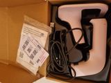 a box with a remote, a charger, and a charger in it