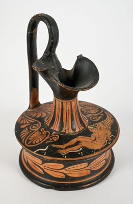a black and orange vase with a bird on it