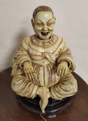 a small statue of a man sitting on a table