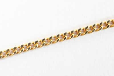 a close up of a gold chain on a white surface