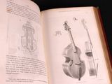 an open book with a drawing of a musical instrument on it