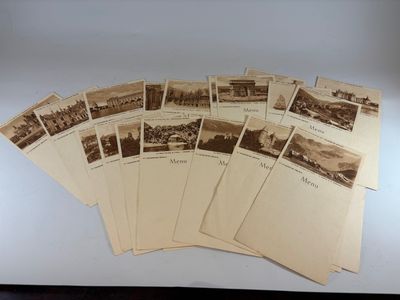 an old photo of a bunch of old postcards sitting on top of a table