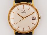 an image of a gold and black watch with a white face
