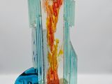 a glass sculpture of a tower with a clock on top of it