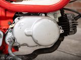 a close up view of a motorcycle engine with a red handlebar