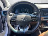 the interior of a car with a steering wheel and dashboard controls