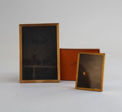 two framed pictures of a man and a woman in a room