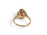 a close up of a gold ring with a pink stone