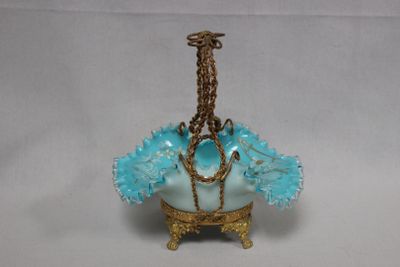 a small blue vase with a chain hanging from it ' s neck