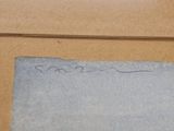 someone is writing on a piece of paper on a table