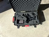 a black case with a gun and other items in it