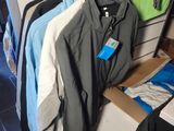 a lot of clothes hanging on a rack in a closet