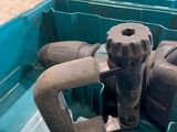a blue container with a couple of hoses in it