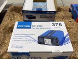 deux boîtes contenant du matériel électronique posées sur une boîte en carton