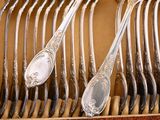a lot of spoons and forks in a box