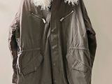a jacket hanging on a hanger on a wall