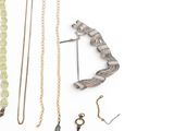 many different types of necklaces on a white surface