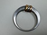 a silver ring with two gold rings on it