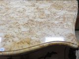 a table with a marble top on a tile floor