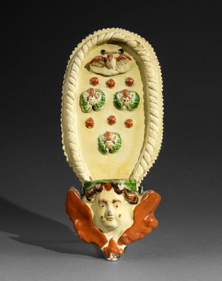 a ceramic sculpture of a woman with flowers on her head