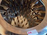 a metal strainer that is sitting on top of a table