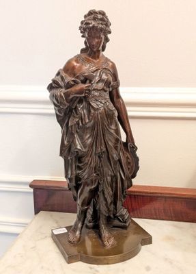 a statue of a woman holding a baby on a marble table