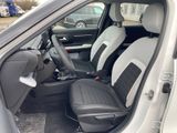 the interior of a small car with two seats and a steering wheel