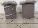 two trash cans sitting on the floor next to each other