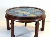 a wooden table with a mosaic top on it