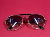 a pair of sunglasses on a red surface