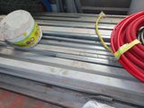 a red hose sitting on top of a metal bench