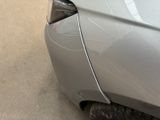 a close up of a car with a denting on the front of it