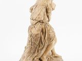 an image of a statue of a woman sitting on top of a tree stump